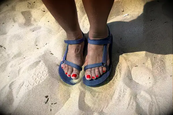 A person wearing the Teva Original Universal Slim Sandal in the sand