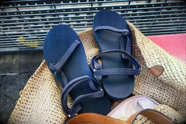 Teva Original Universal Slim Sandal in a rattan beach bag