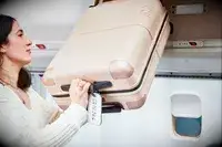 Person lifting the July Carry On into an overhead bin