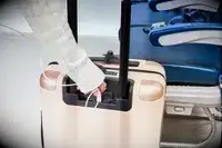 Hand plugging a USB cord into the July Carry On