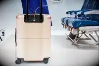 USB cord plugged into the July Carry On