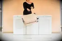 Person throwing July Carry-On luggage off of a counter