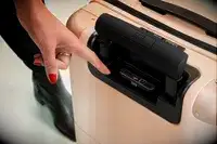 Hand pointing at the USB ports on the July Carry On