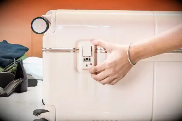 Hand touches the lock on a July Trunk Set piece