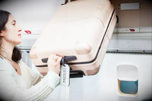 Person lifting the July Carry On into an overhead bin