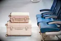 The July Trunk Set in front of airplane seats