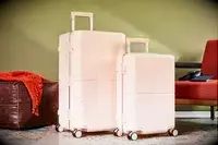 July Trunk Set in front of a green wall near ottoman and chair
