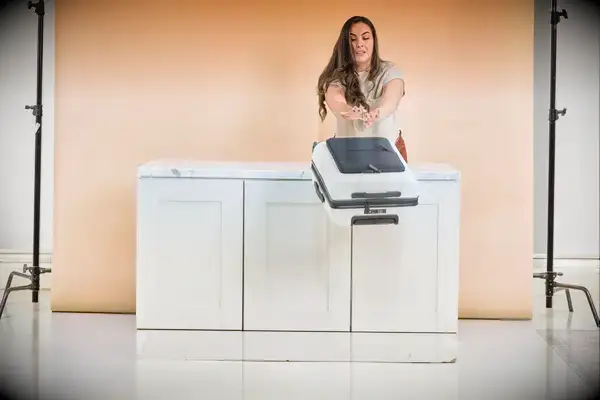 A person shoves a July Carry On Pro SnapSleeve off a counter during testing