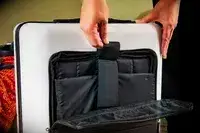 Hands open the sleeve on a July Carry On Pro SnapSleeve