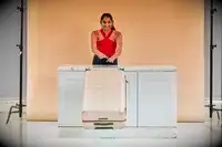 Person pushing a July Checked Plus Large Luggage off a counter