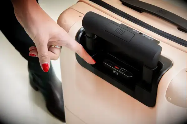 Hand pointing at the USB ports on the July Carry On