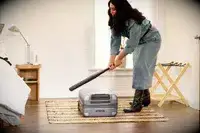 A person hits the July Carry-on Max with a baseball bat