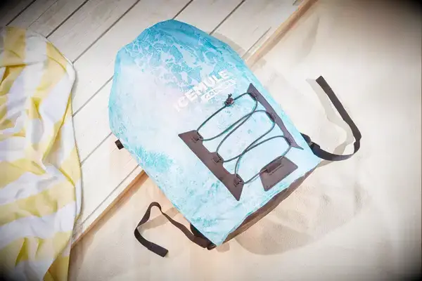 A Yeti Hopper Flip 12 Soft Cooler sits outdoors in foliage