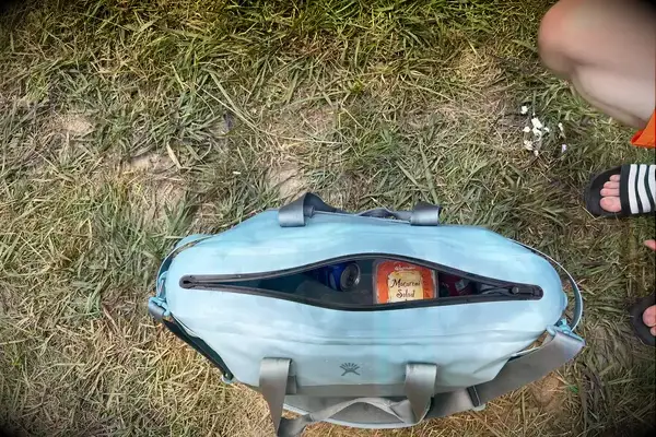 Overhead view of the Hydro Flask 26 L Day Escape Soft Cooler Tote in the grass