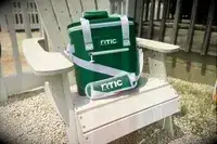 The RTIC Insulated Soft Cooler Bag displayed on a chair outdoors