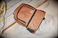 Carhartt 2-in-1 Insulated Cooler Backpack displayed on sand