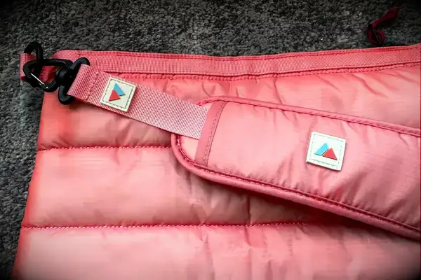 The logos on the strap on the Monti The Mayfly 14L Cooler