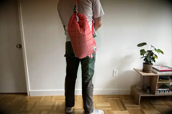 A person carries the Monti The Mayfly 14L Cooler by the strap