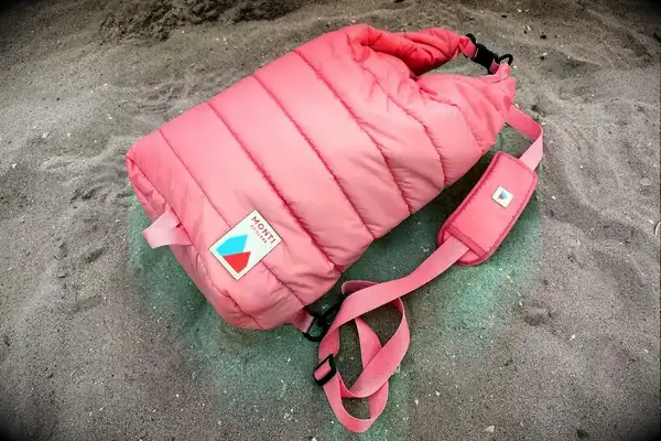 The Monti The Mayfly 14L Cooler sits in sand