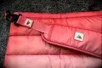 The logos on the strap on the Monti The Mayfly 14L Cooler