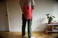 A person carries the Monti The Mayfly 14L Cooler by the strap