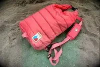 The Monti The Mayfly 14L Cooler sits in sand