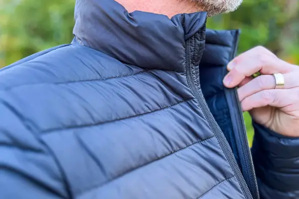 A person holds open the Save The Duck Erion Packable Quilted Puff Jacket