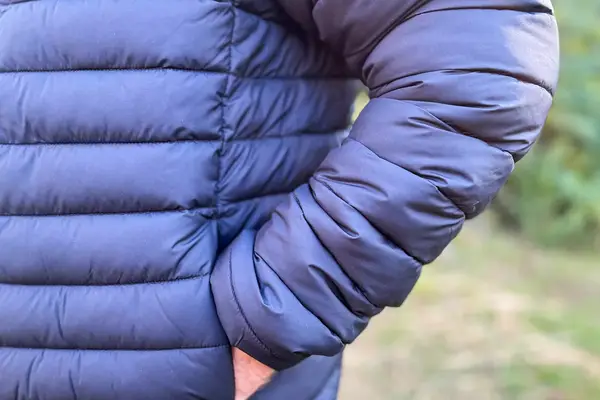 A person with their hand in the pocket of the Save The Duck Erion Packable Quilted Puff Jacket