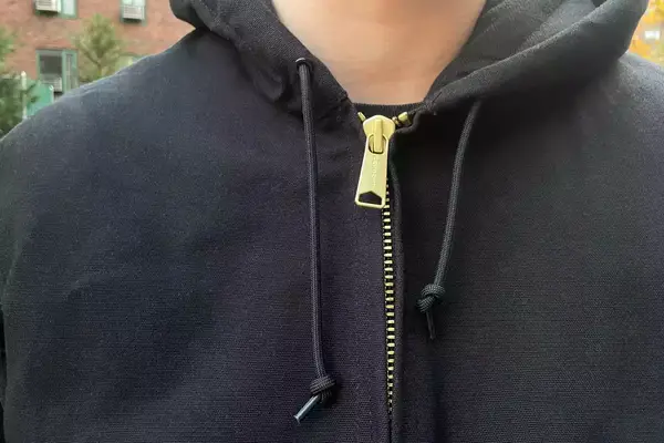 A person touches the fabric on the Cotopaxi Calidez Men