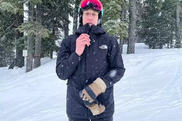 Close up of Person In Goggles Zipping Up The North Face Men