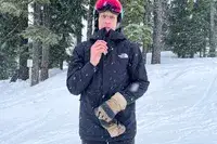 Close up of Person In Goggles Zipping Up The North Face Men