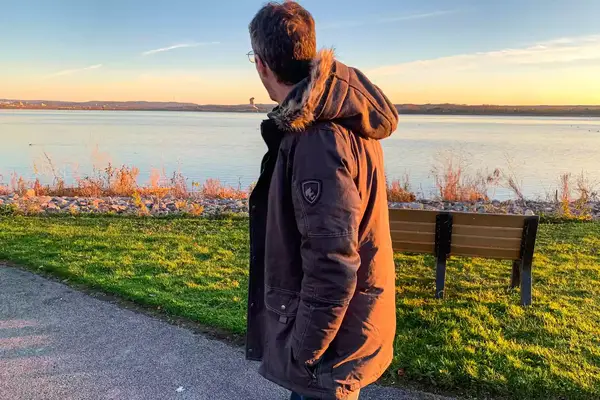 A person walks outside while wearing the Kuhl Men