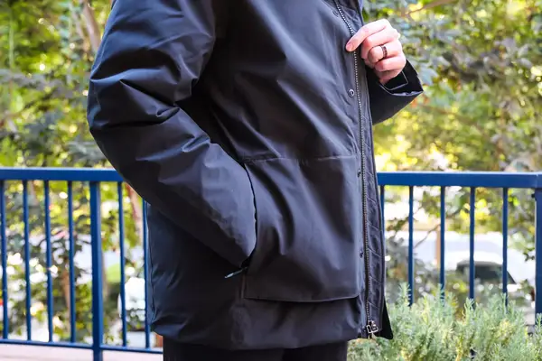 A person touches the fabric on the Cotopaxi Calidez Men