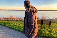 A person walks outside while wearing the Kuhl Men