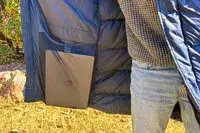 A person shows a laptop in the Helly Hansen Men