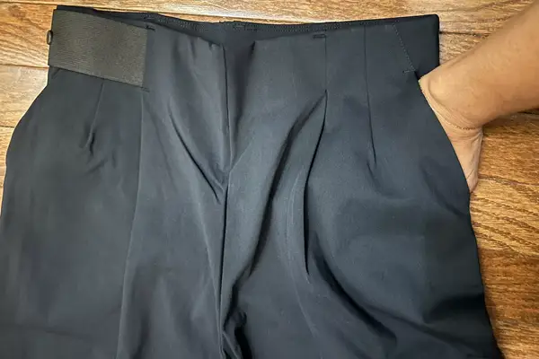 A person places their hand inside the pocket of the Aday Turn It Up Pants