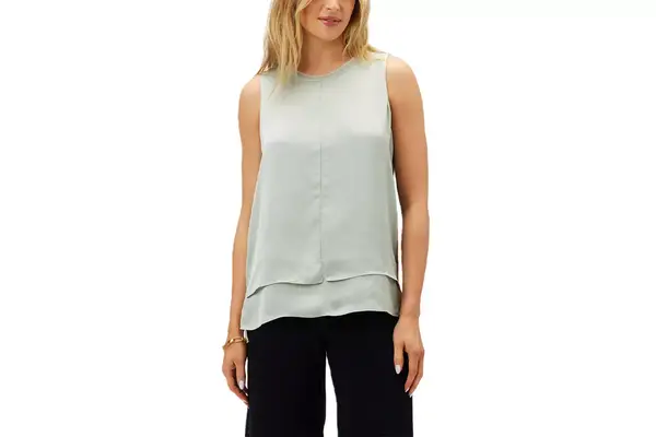 A person places their hand inside a pocket in the Aday Turn It Up Pants