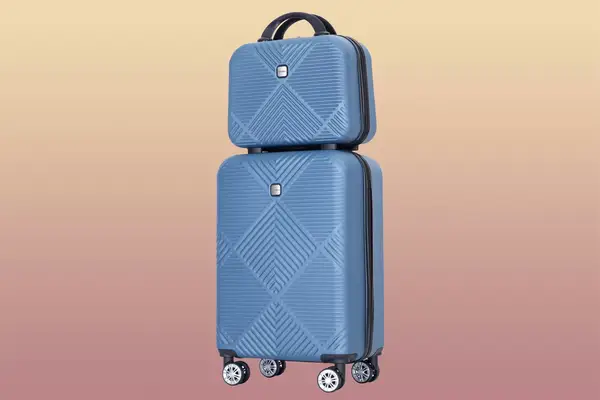 Blue Tripcomp Luggage Set on a sunset gradient background
