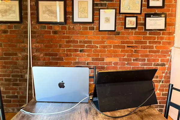 Back view of opened ARZOPA Portable Monitor next to an opened macbook pro.