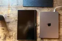 Above view of ARZOPA Portable Monitor next to a closed macbook pro.