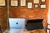 Back view of opened ARZOPA Portable Monitor next to an opened macbook pro.