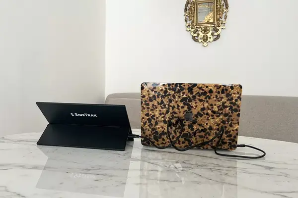 SideTrak Solo Pro Touch FHD 13.3 next to a laptop on a marbled table
