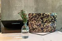 The SideTrak Solo Pro Touch FHD 13.3 next to a laptop sitting on a cafe table