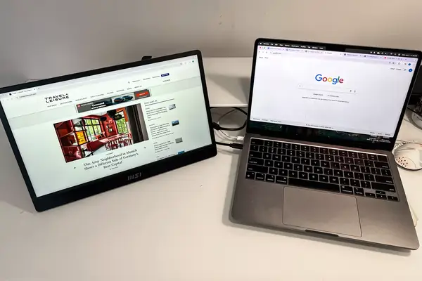 MSI Pro MP161 E2 Portable Monitor next to macbook pro on a table.