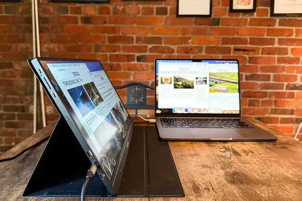 Side view of opened ARZOPA Portable Monitor next to an opened macbook pro.