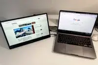 MSI Pro MP161 E2 Portable Monitor next to macbook pro on a table.