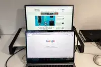 MSI Pro MP161 E2 Portable Monitor on a shelf above the macbook pro.