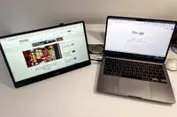 MSI Pro MP161 E2 Portable Monitor next to macbook pro on a table.