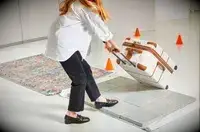 Delsey Paris Chatelet Air 2.0 26 Inch Trunk being rolled onto tile