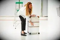 A person holding the Delsey Paris Chatelet Air 2.0 26 Inch Trunk